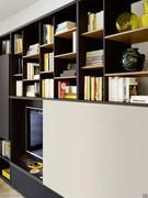 Detail of the partitions with uprights in charcoal oak and shelves in bronze metallic lacquer and the sliding door in back-lacquered glass