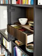 Detail of the heat-treated oak drawers placed inside the display cabinets