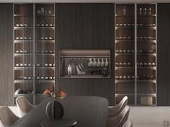 Lounge bar compartment sandwiched between two wardrobe columns from the same collection, equipped with bottle shelves and glass doors