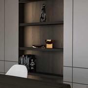 Hinged cupboard doors in matt lacquer (Canvas) and a central bookcase unit