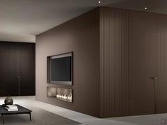 Storage wall with TV compartment and Lounge fireplace proposed here as part of a furnishing system that makes it possible to create totally coordinated living and sleeping environments 