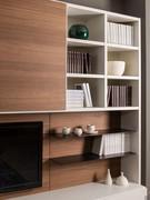 Open compartments and metal shelves on the Way 28 wall are ideal for bookcase use or to display small items