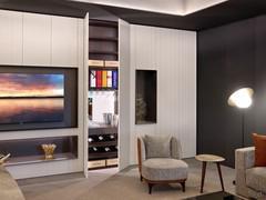 Lounge wardrobe column with two hinged doors inserted in a composition with elements from the same collection and equipped with a bar with glass shelves, bottle holders and internal drawer