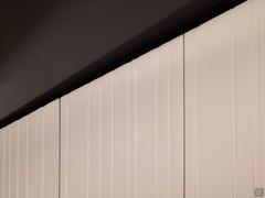 Detail of the 80:40 machining, available on lacquered doors along with many others to further customise the finish of your wardrobe column