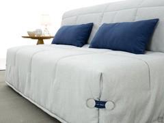 Détail du revêtement matelassé en tissu avec cordonnets et boutons