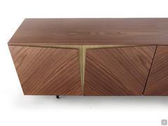 Particolare della credenza di design con ante scultoree Stella che mette in risalto la finitura bicolore legno/bronzo