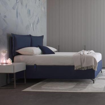 MilleLetti fabric upholstered bed with an electric storage bed mechanism, in the version with a 30 cm high bed frame and headboard with applied cushions