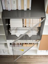 Detail of the glass door opening and internal clear glass shelf