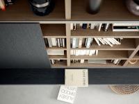 Detail of the wall-mounted TV unit in two shades of wood veneer