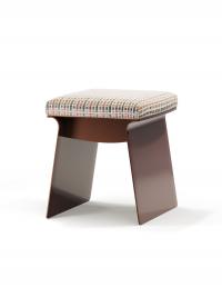 The Calvin pouffe stool with an open metal structure and seat cushion upholstered in fabric