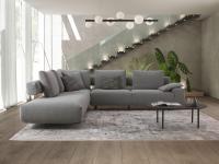 Shirley sofa characterised by its open backrest: a suspended backrest supported by a metal frame and with loose cushions