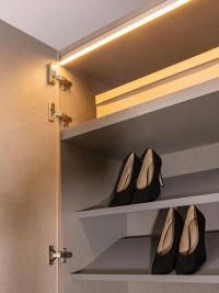 Detail of inclined shoe shelf in titanium painted metal