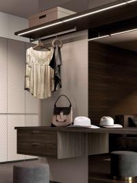 Horizon walk-in closet equipped with wooden shelves and LED lighting. In the lower part drawers and shelves are finished with a leather top