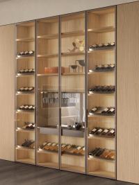 Lounge showcase made from wardrobe column with clear glass doors, equipped with inclined shelves, glass holder and central drawer