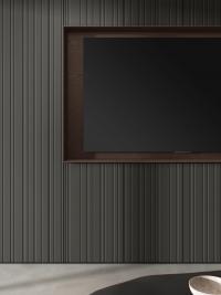 Detail view of the 80:40 processing of the anthracite matt lacquered fronts combined with the TV compartment and wall shelves in mocha wood veneer