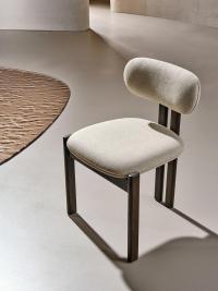 Mailea here proposed in a version without armrests and with legs in solid Moka ash wood