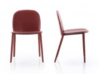 Front and side view of the Makalu armless chair, highlighting its low, curved backrest 