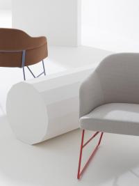 Sophos modern upholstered chair with a fabric cover and a thin lacquered metal sled base